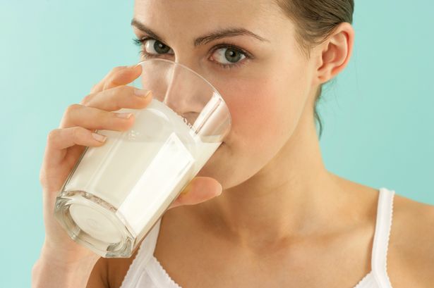 Young woman drinking from a glass